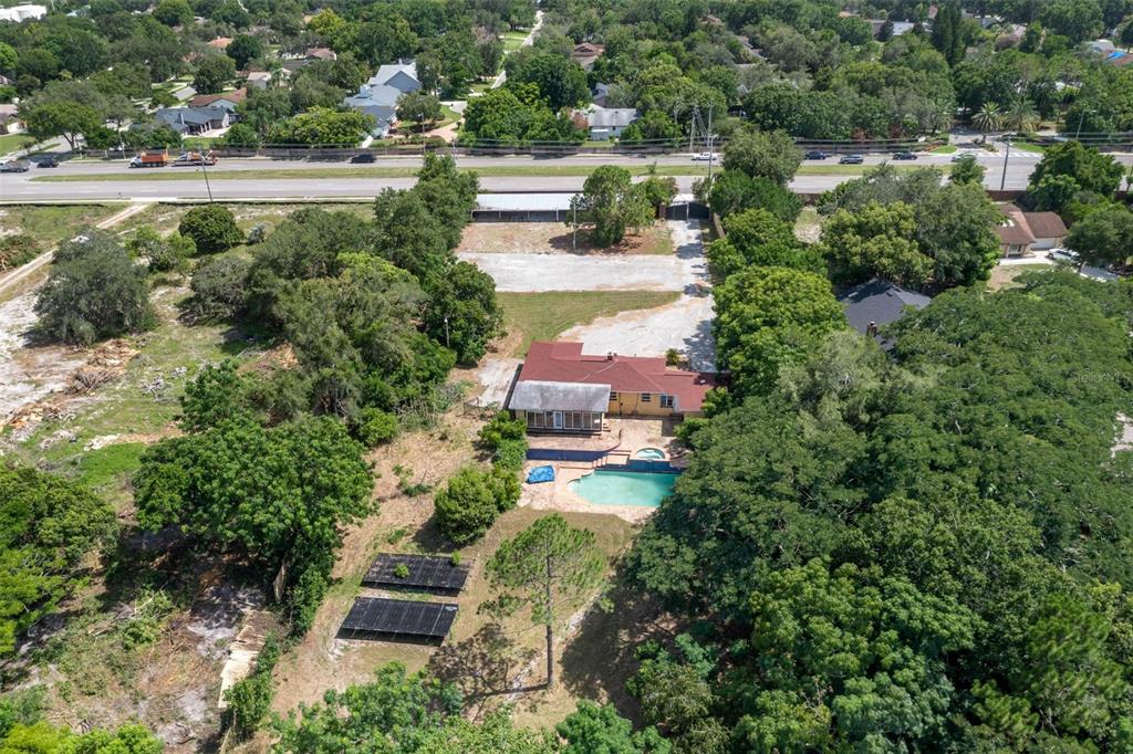 an aerial view of house with yard swimming pool and outdoor seating