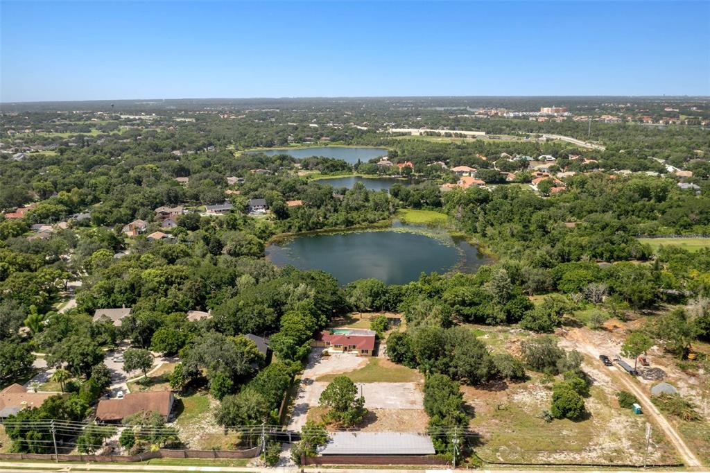 7775 Conroy Windermere Road Orlando, FL 32835 - Photo 2 of 3 an aerial view of residential houses with outdoor space and ocean view
