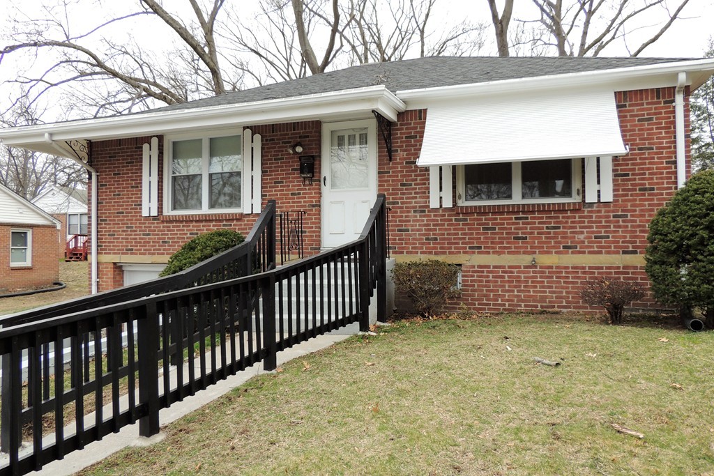 52 Carnavon Circle Springfield, MA 01109 - Photo 1 of 16 a view of a house with a small yard and wooden fence