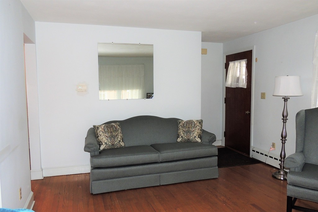 52 Carnavon Circle Springfield, MA 01109 - Photo 4 of 16 a living room with furniture and a window