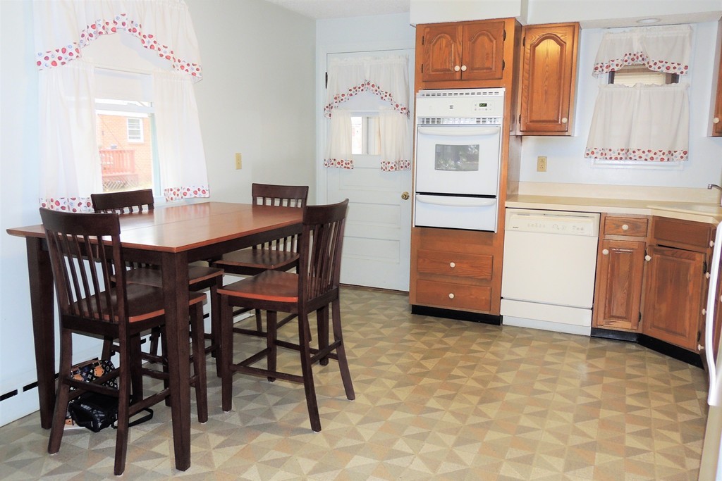 52 Carnavon Circle Springfield, MA 01109 - Photo 5 of 16 a kitchen with stainless steel appliances granite countertop a stove a table and chairs