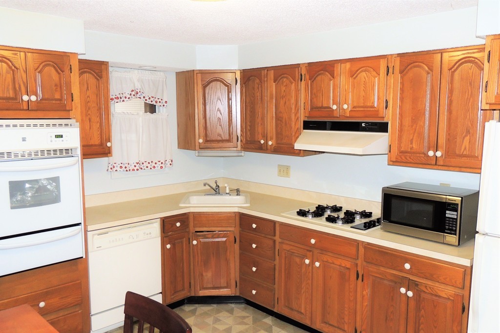 52 Carnavon Circle Springfield, MA 01109 - Photo 6 of 16 a kitchen with stainless steel appliances granite countertop a refrigerator a stove a sink and cabinets
