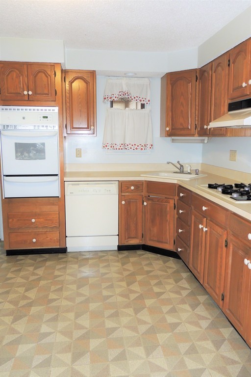 52 Carnavon Circle Springfield, MA 01109 - Photo 7 of 16 a large kitchen with granite countertop a sink and a stove