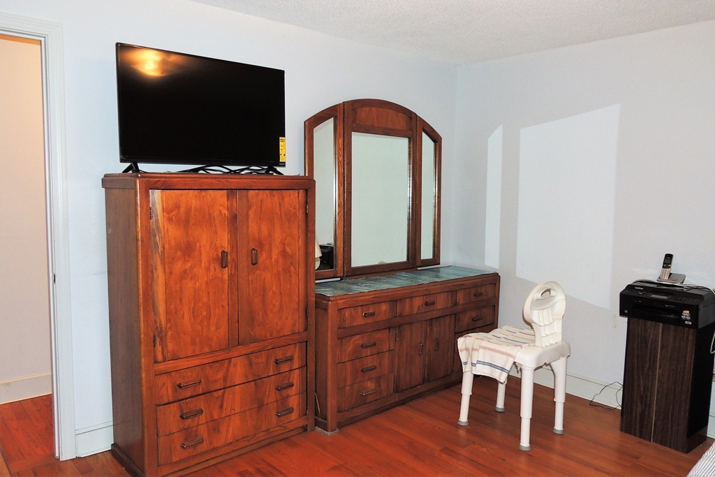 52 Carnavon Circle Springfield, MA 01109 - Photo 10 of 16 a living room with furniture a flat screen tv and wooden floor