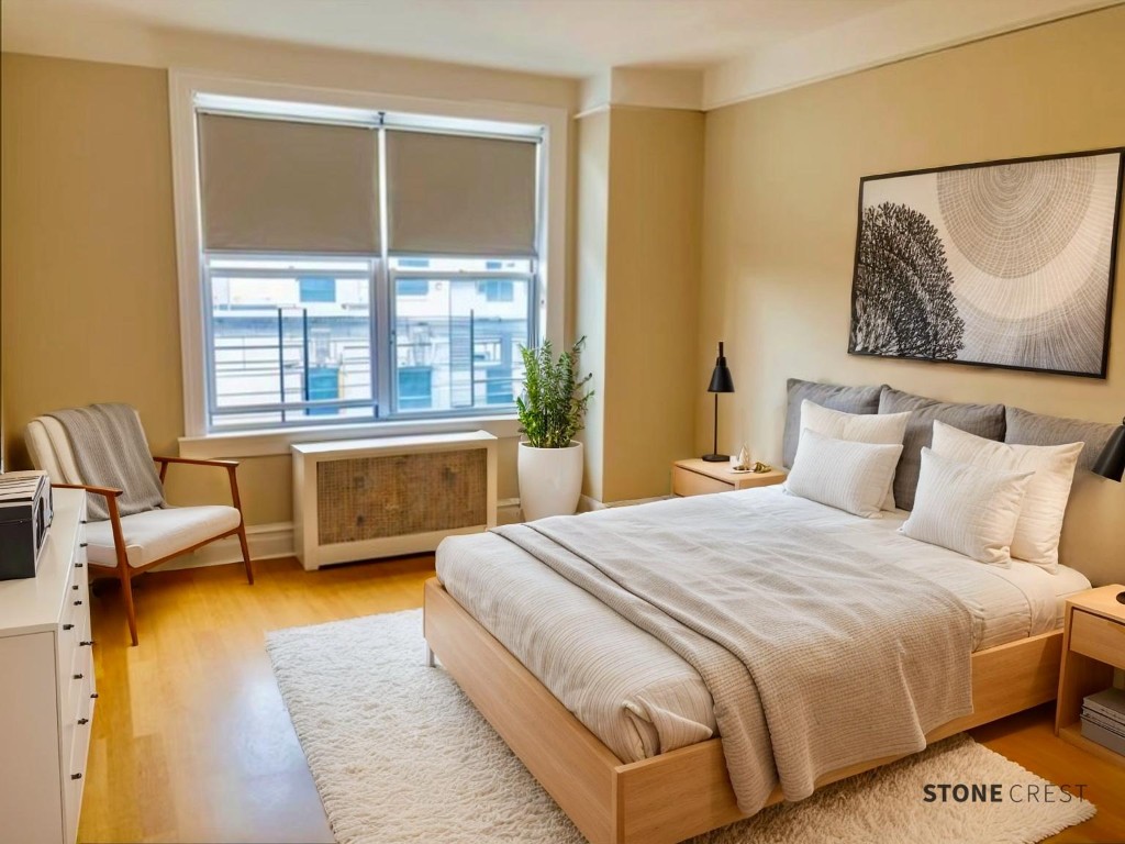 425 Riverside Drive, Unit 7I Manhattan, NY 10025 - Photo 9 of 14 a bedroom with a bed couch and a large window