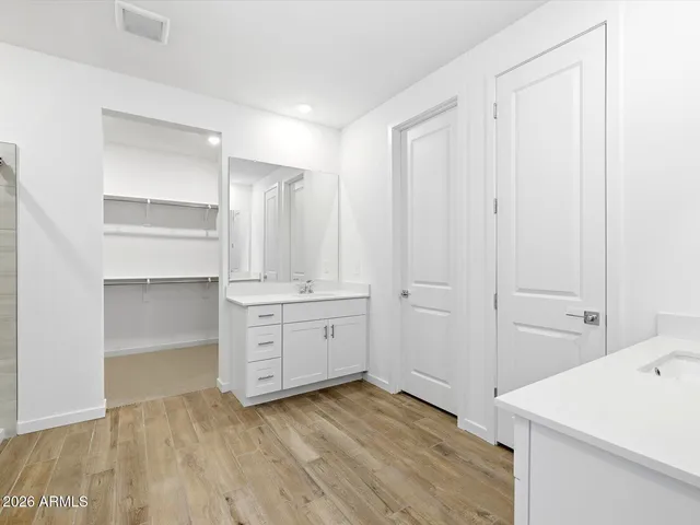 an empty room with closet and windows