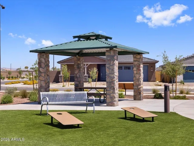 a view of a house with swimming pool and sitting area