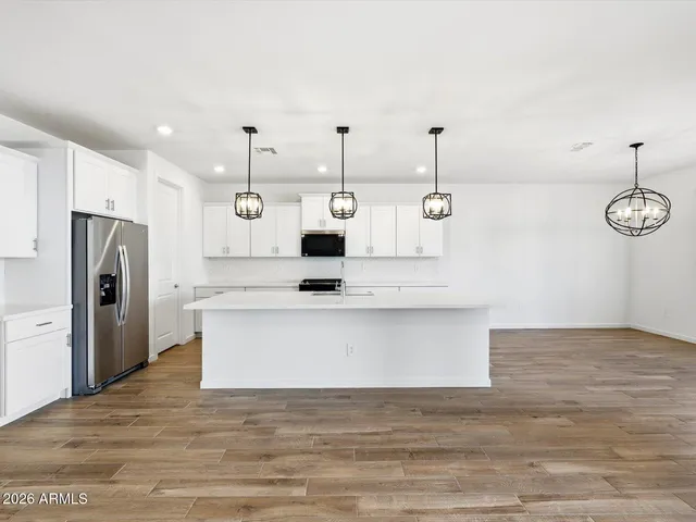a kitchen with stainless steel appliances a counter space cabinets and stainless steel appliances