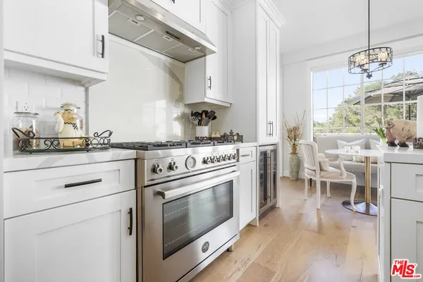 a kitchen with stainless steel appliances granite countertop a stove and a cabinets