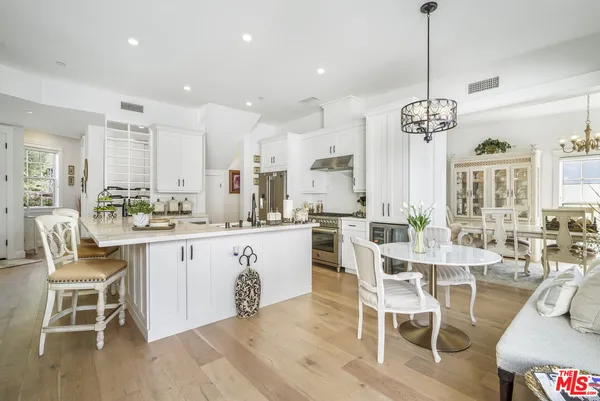 a large kitchen with a table and chairs