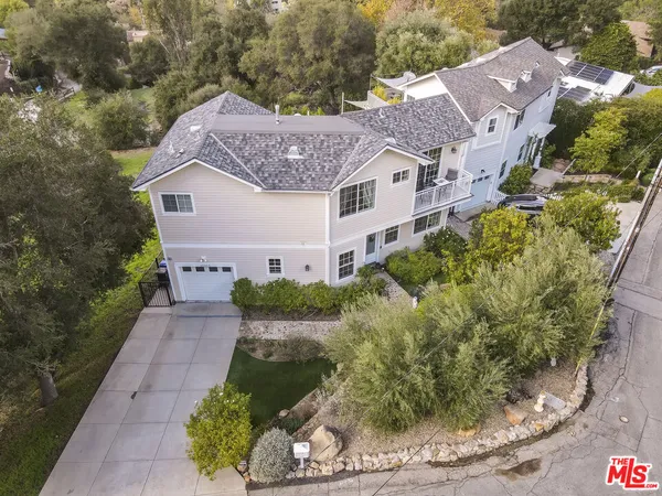 a aerial view of a house with a yard and garage
