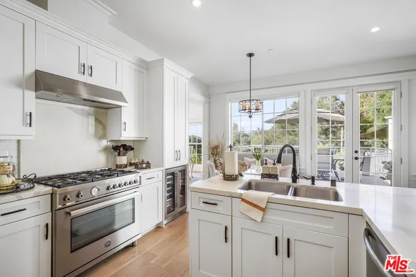 a kitchen with appliances a sink and cabinets