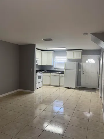 a large kitchen with cabinets and a stove top oven
