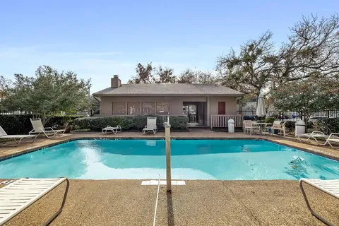 a view of a swimming pool with lounge chairs