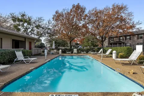 a brick house with trees in front of it