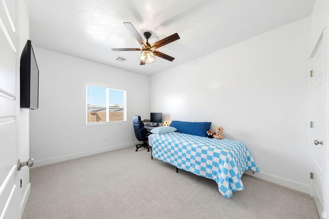 5963 Flattop Drive St. George, UT 84790 - Photo 29 of 45 Light-filled room featuring neutral carpeting, a window with horizontal blinds, and a ceiling fan with integrated lighting