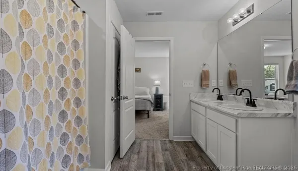 a bathroom with a double vanity sink and mirror