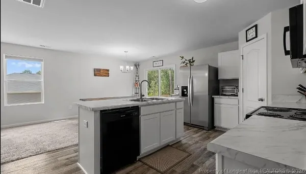 a kitchen with a sink stove and refrigerator