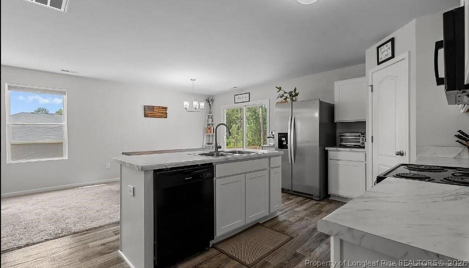172 Mildred Way Road Aberdeen, NC 28315 - Photo 6 of 7 a kitchen with a sink stove and refrigerator