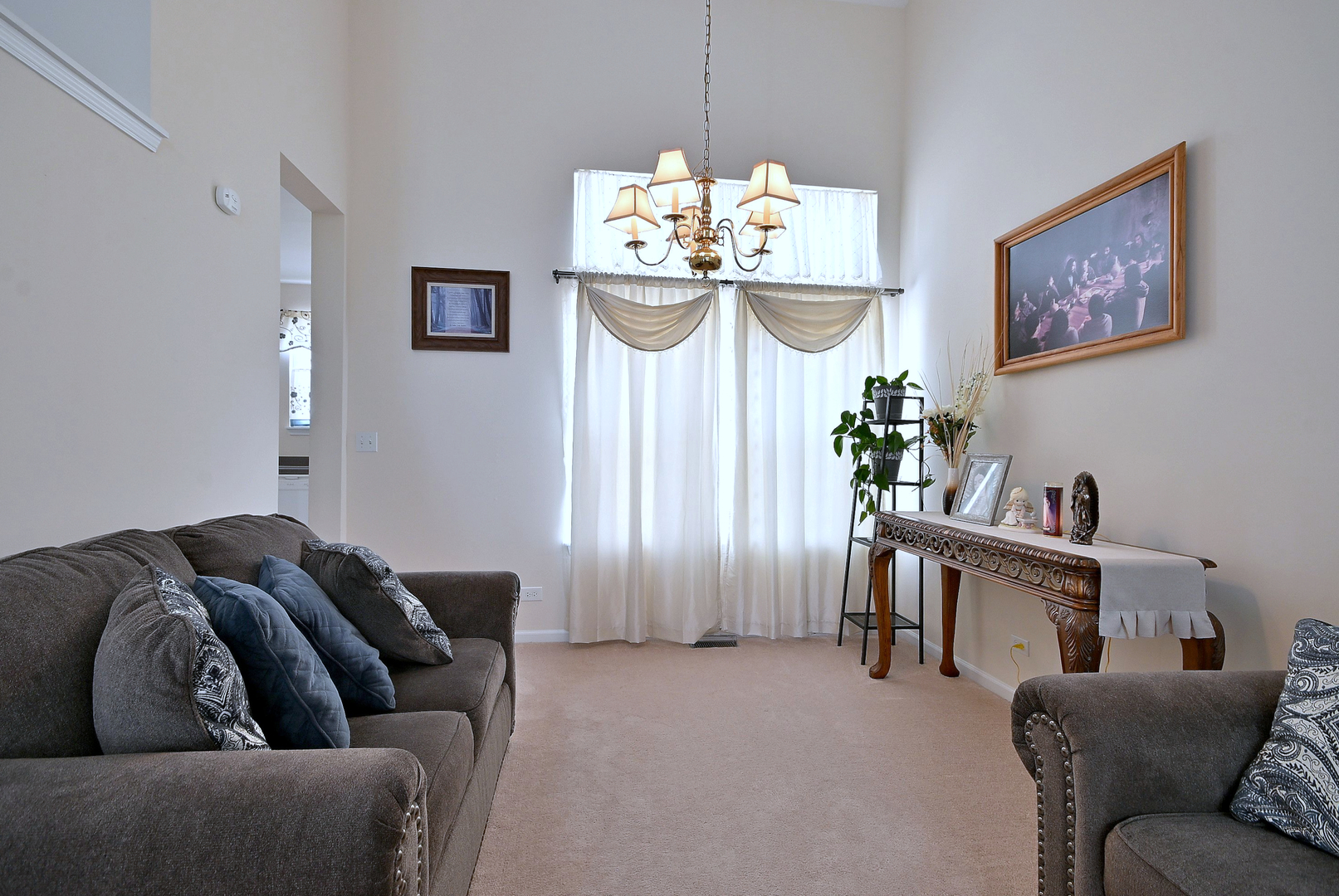 230 Stickley Lane Lake In The Hills, IL 60156 - Photo 11 of 52 a living room with furniture a chandelier and a window