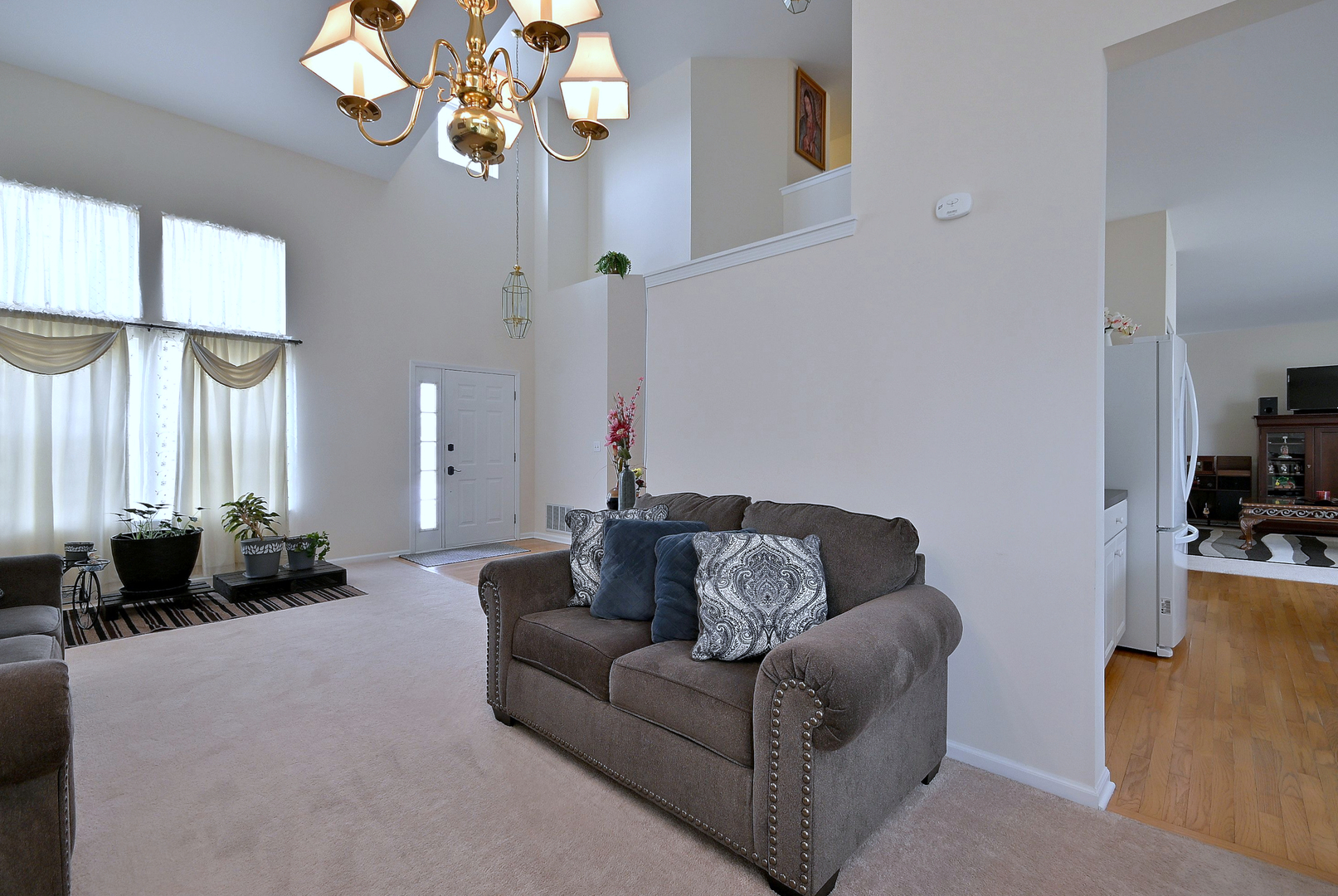 230 Stickley Lane Lake In The Hills, IL 60156 - Photo 13 of 52 a living room with furniture chandelier and a large window