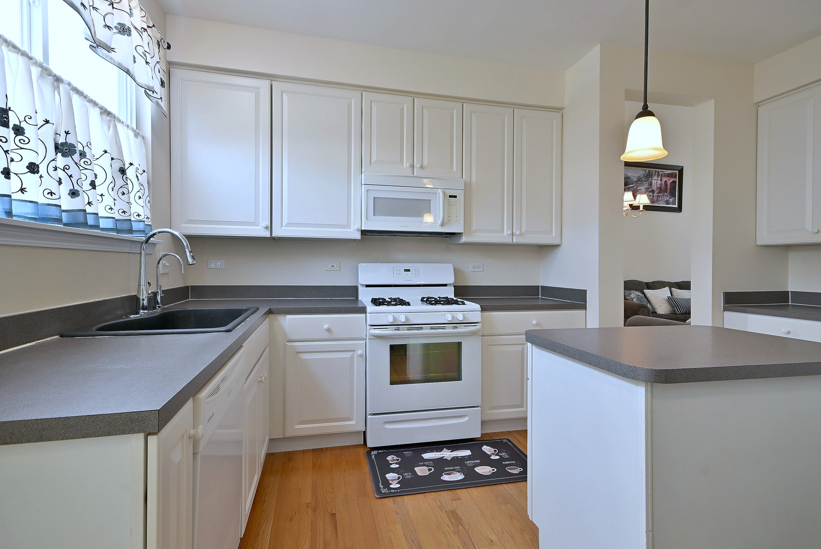 230 Stickley Lane Lake In The Hills, IL 60156 - Photo 19 of 52 a kitchen with a sink stove and cabinets