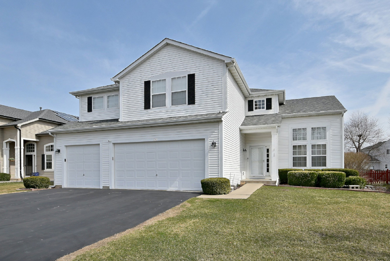 230 Stickley Lane Lake In The Hills, IL 60156 - Photo 2 of 52 a front view of a house with a yard and garage