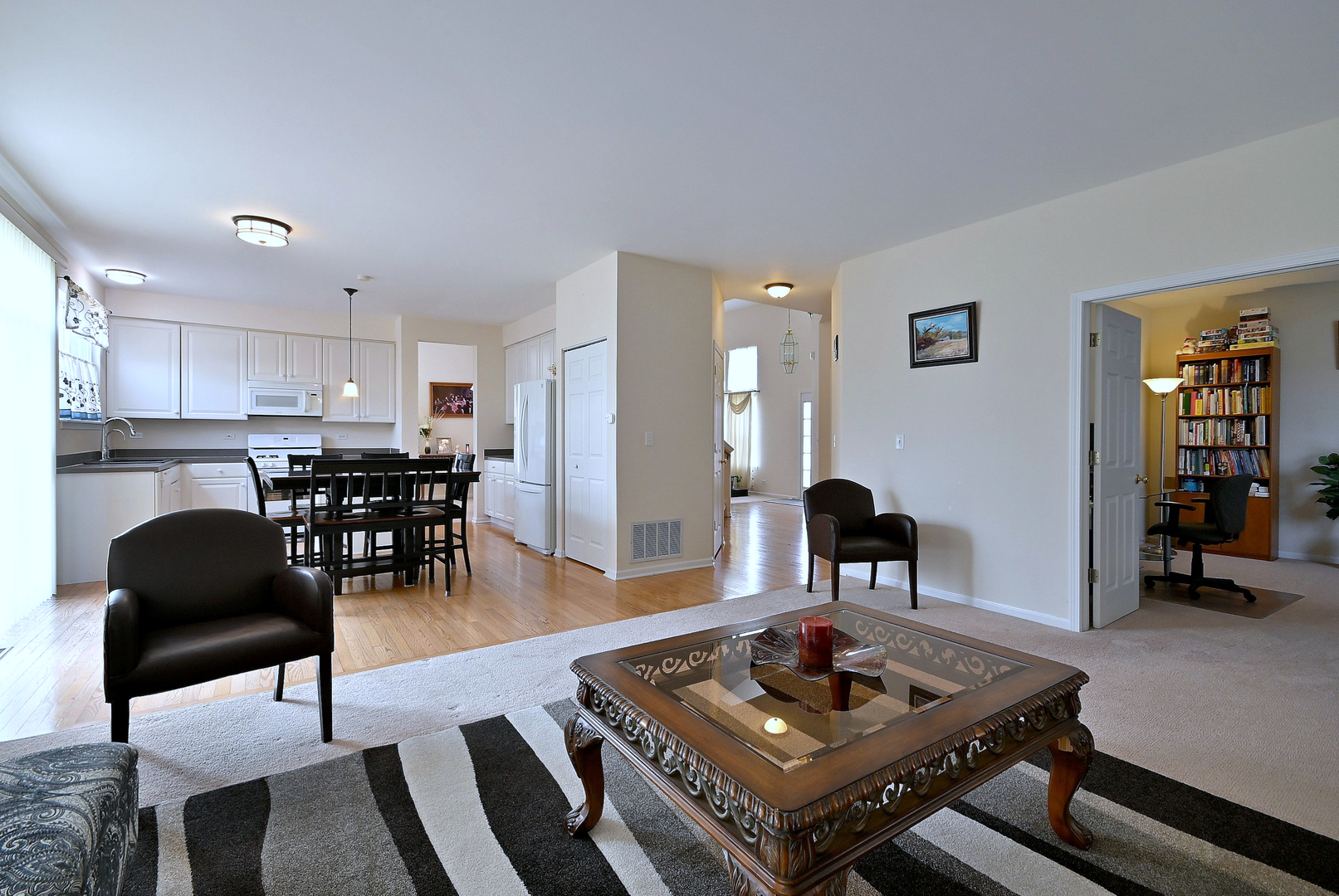 230 Stickley Lane Lake In The Hills, IL 60156 - Photo 22 of 52 a living room with furniture and a table with wooden floor