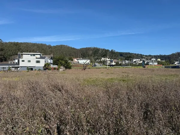 a view of a town with mountains in the background