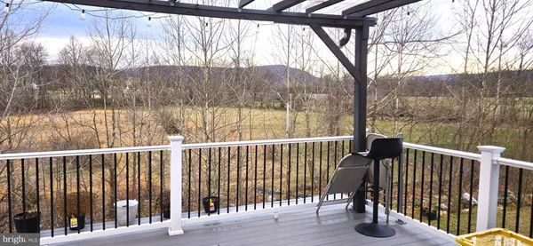 a view of a balcony with wooden floor and fence