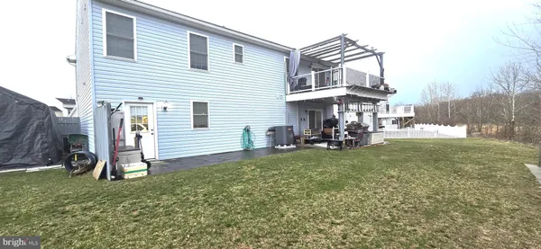 a view of a house with backyard porch and garden