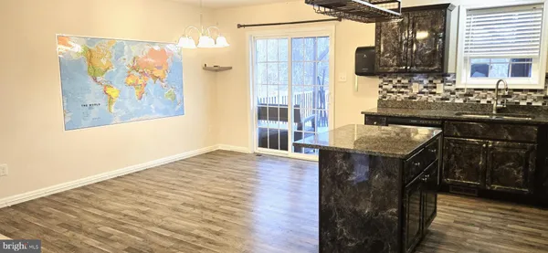 a kitchen with stainless steel appliances granite countertop a stove and a wooden cabinets