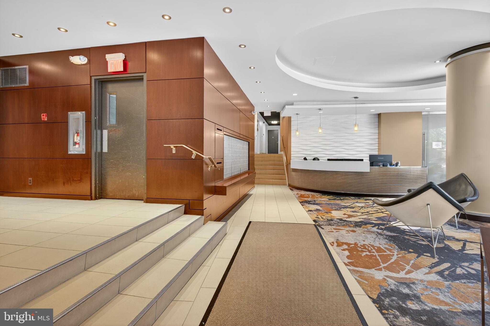 2201 L Street Northwest, Unit 316 Washington, DC 20037 - Photo 20 of 20 a bedroom with a bed and a large mirror