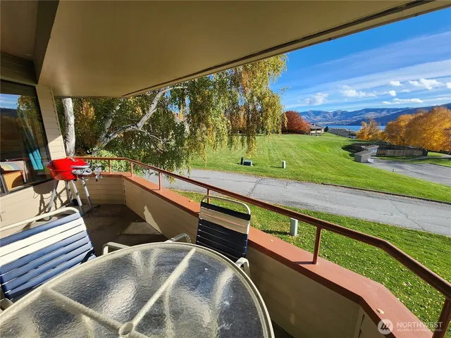 a view of a porch with furniture and a yard
