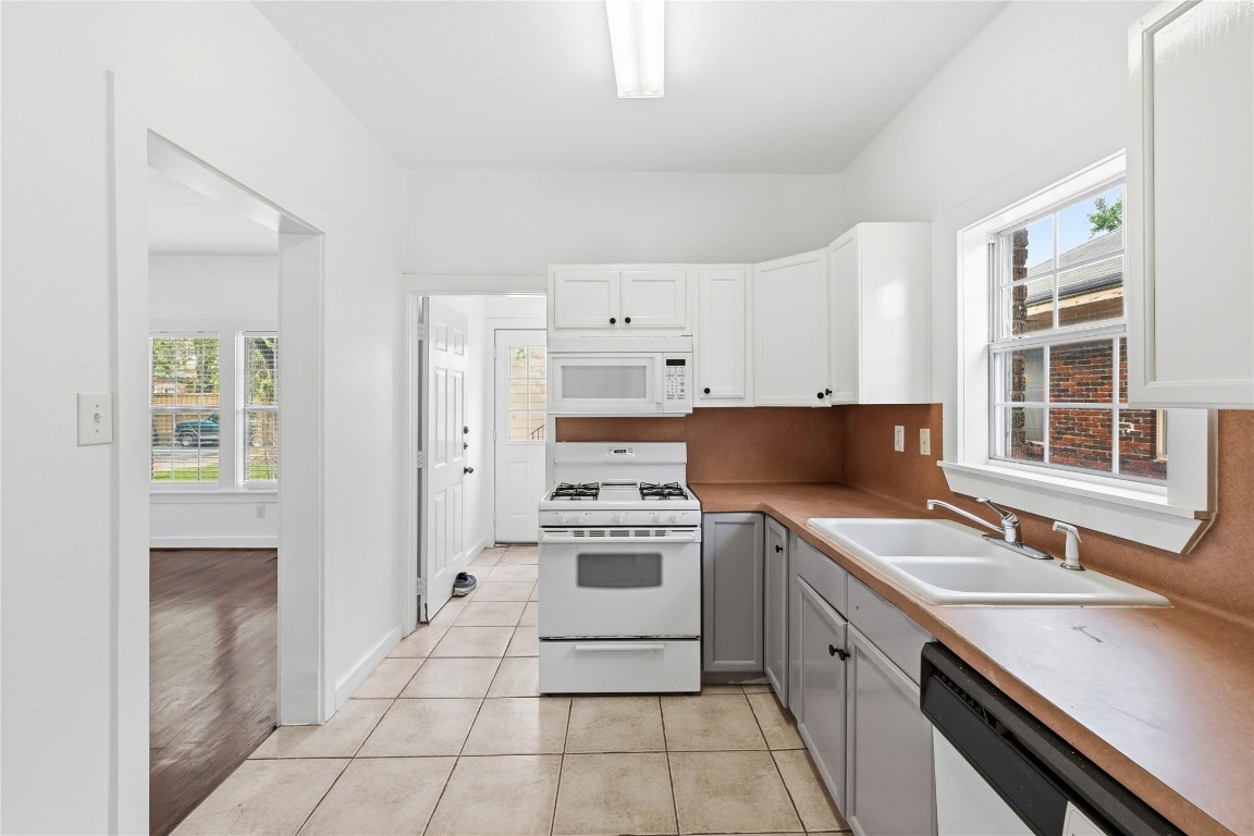 2218 Arbor Street, Unit ABC Houston, TX 77004 - Photo 3 of 43 Bright open kitchen equipped with gas stove and a window over the sink providing natural light and outdoor views.