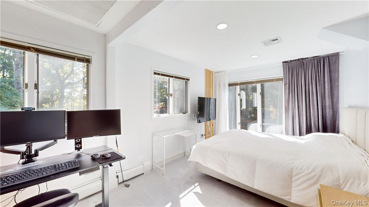 96 Old Pascack Road Pearl River, NY 10965 - Photo 26 of 41 a bedroom with a large bed and a computer on desk