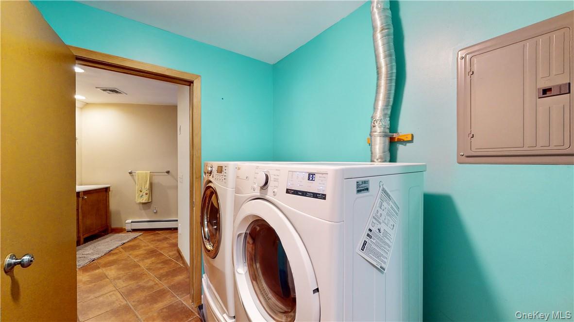 96 Old Pascack Road Pearl River, NY 10965 - Photo 28 of 41 a view of washer and dryer with kitchen in the background