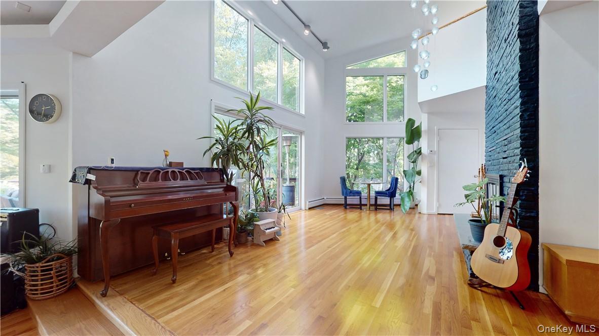 96 Old Pascack Road Pearl River, NY 10965 - Photo 6 of 41 a living room with furniture a piano and a floor to ceiling window