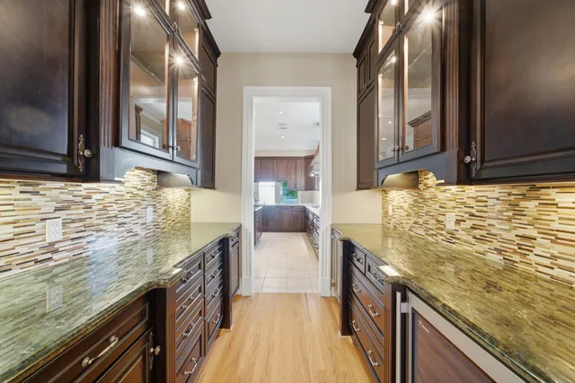 a kitchen with granite countertop counter top space a sink stainless steel appliances and cabinets