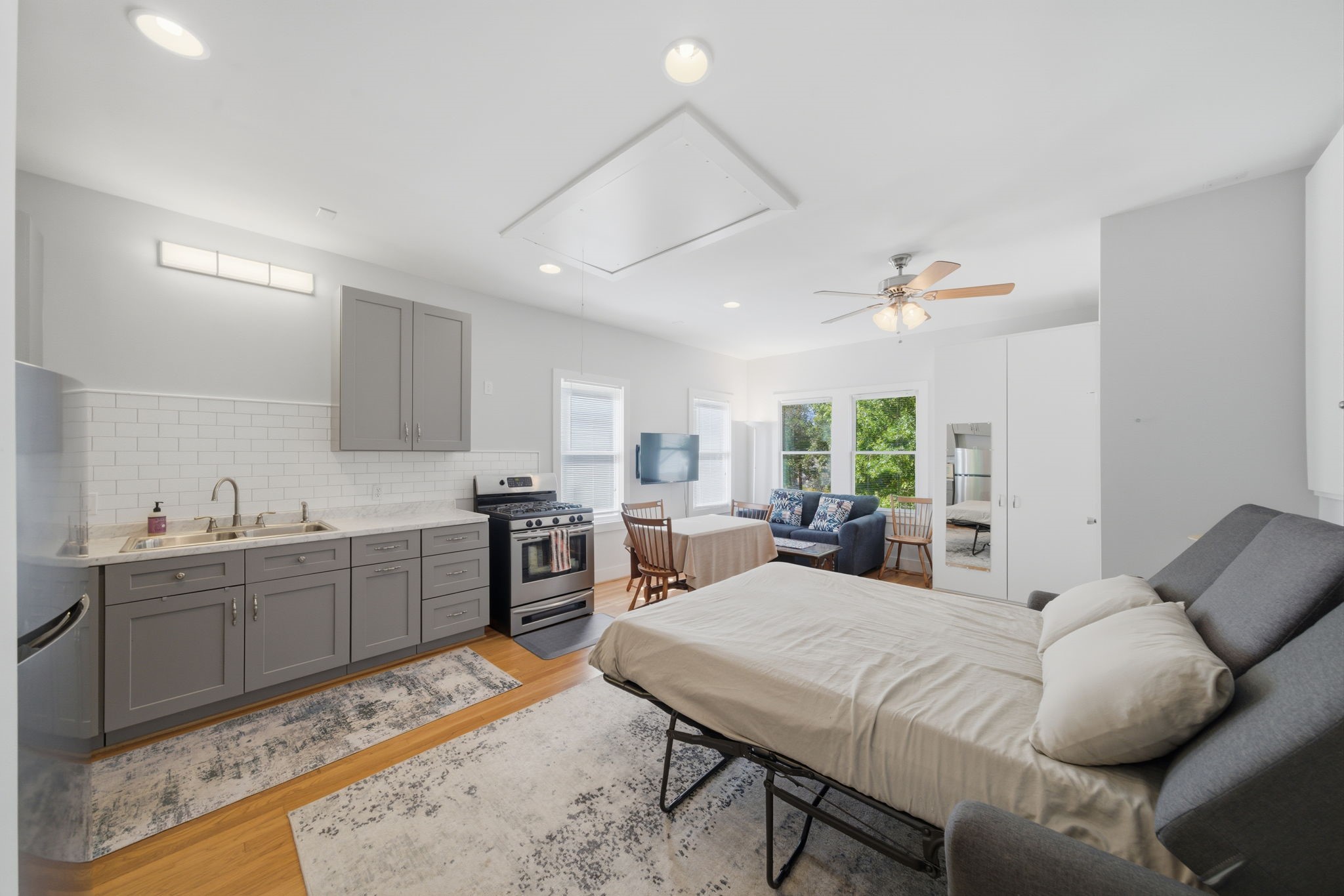 607 East 15th Street Houston, TX 77008 - Photo 30 of 45 a living room with furniture a large window and kitchen view