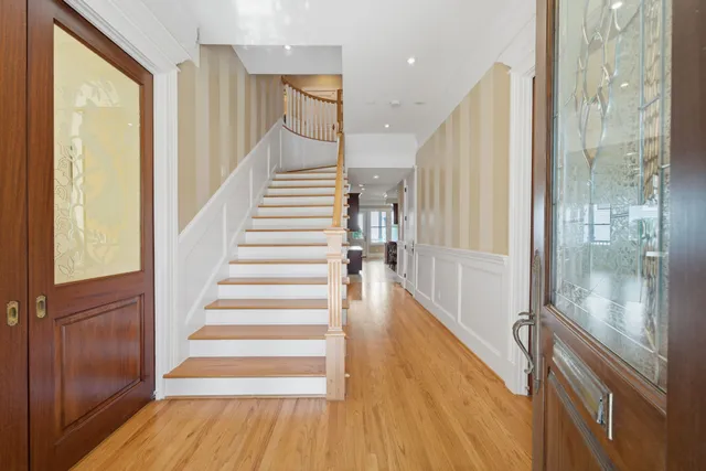 a view of entryway with wooden floor and stairs