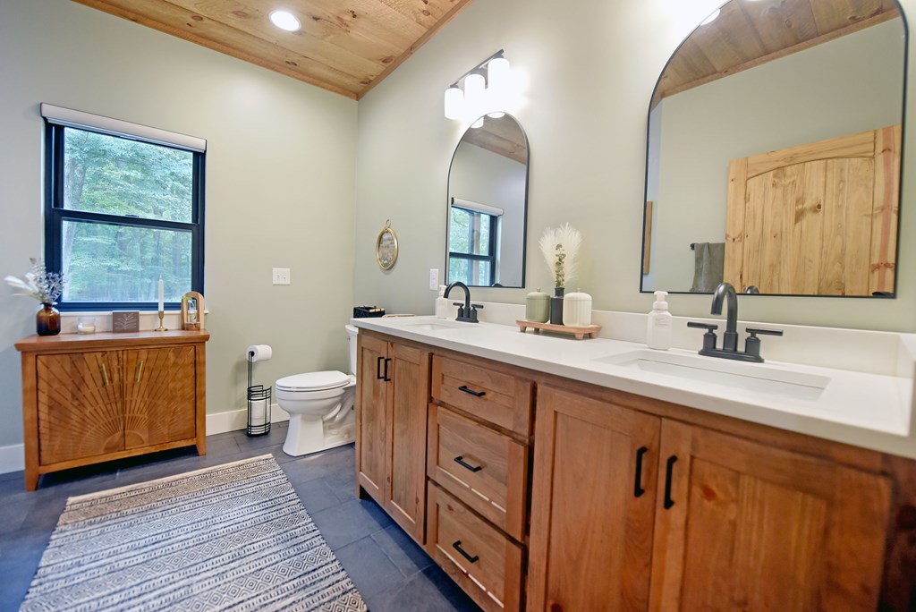 954 Tipton Springs Road Morganton, GA 30560 - Photo 22 of 49 a spacious bathroom with double vanity two mirror and a window