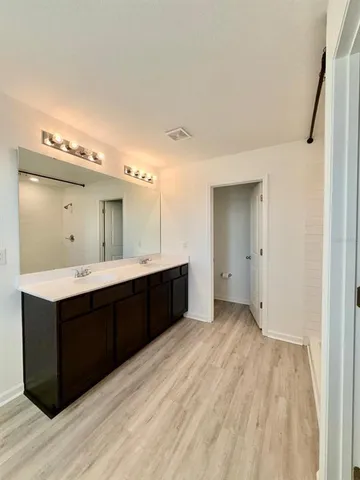 a bathroom with a shower and a glass door