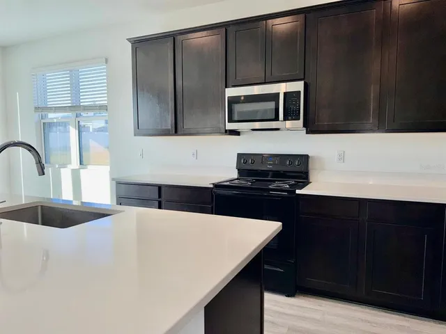 a kitchen with a sink and a microwave