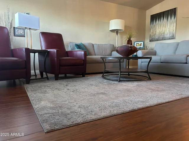 a living room with furniture and a rug