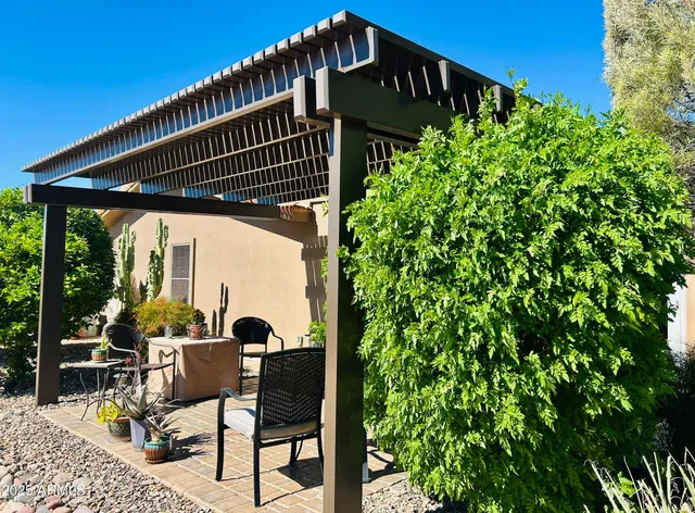 a view of a house with a tree and a yard