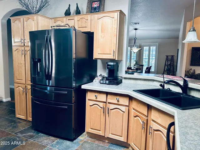 a view of a dining room with furniture and chandelier