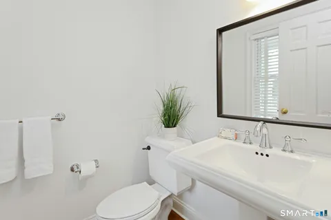 a bathroom with a sink mirror and toilet