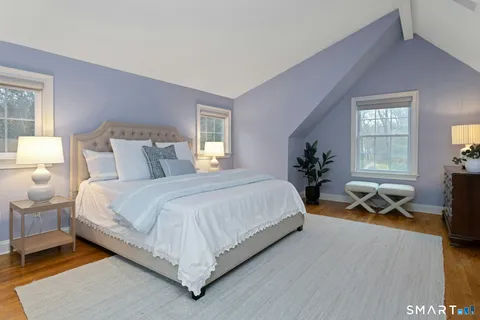 a spacious bedroom with a bed and a table in it