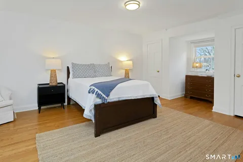 a spacious bedroom with a bed and a table in it